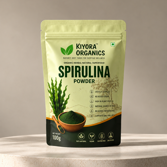Kiyora Organics Spirulina Powder pouch, 100g, on a stone pedestal